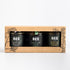 trio of honeys in a brown paper gift set on a white background