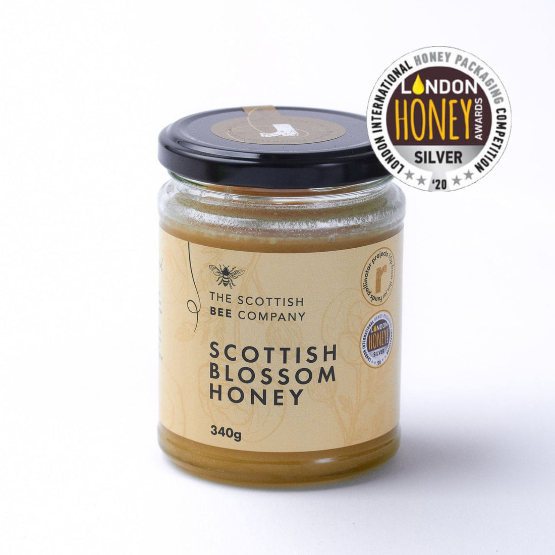 Jar of Scottish Blossom Honey from The Scottish Bee Company with a silver award badge on a white background
